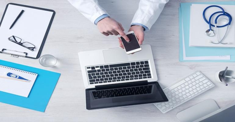 doctor using a phone on his table