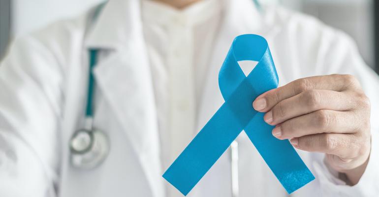 doctor-holding-blue-ribbon-for-mens-health-awareness.jpg